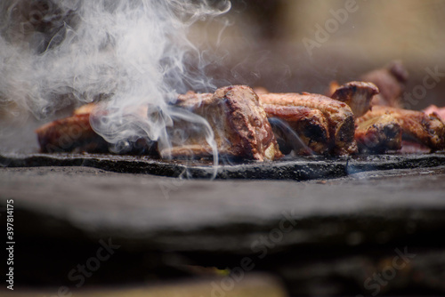 Meat on the grill outdoors. Ribs barbecue on the grill. Selective focus photography.