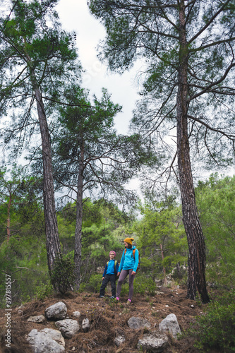 A child with his mother on a hike to the mountains