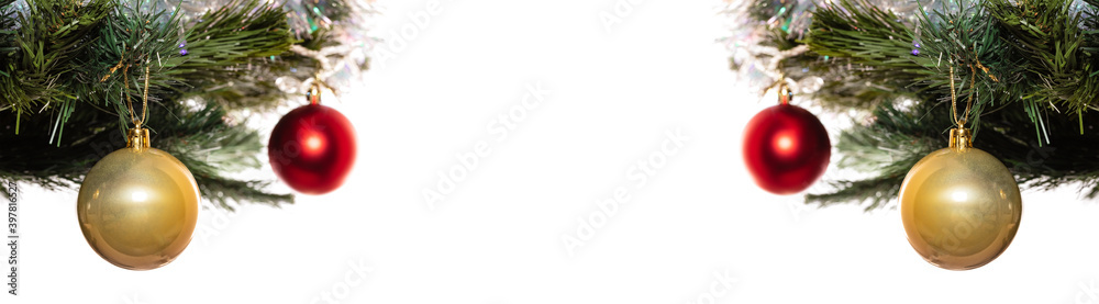 Decorative glass golden and red balls ornaments on Christmas trees. Red balls and trees are blurred. Isolated on white background. Winter holiday decoration concept. Banner size, copy space Decorative glass golden and red balls ornaments on Christmas trees. Red balls and trees are blurred. Isolated on white background. Winter holiday decoration concept. Banner size, copy space