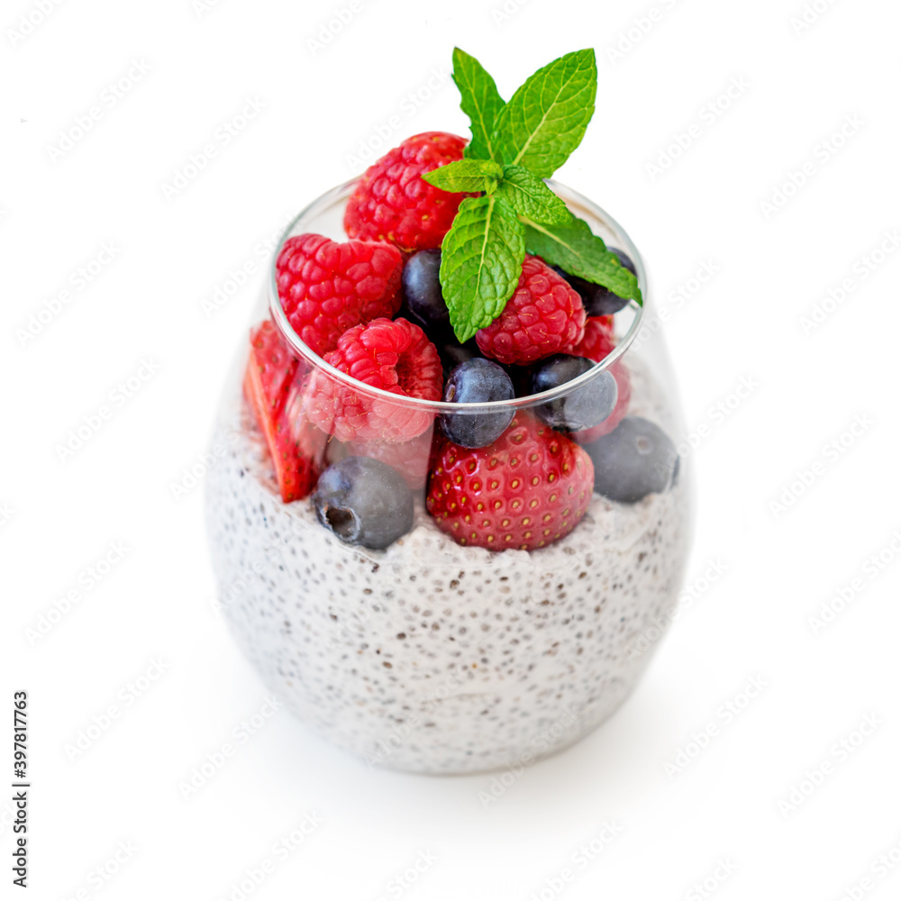 Glass of Chia seed pudding with fruits and fresh berries isolated on white background. Chia seeds Yogurt. Glass of Chia seed pudding with fruits and fresh berries isolated on white background. Chia seeds Yogurt.