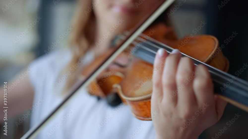 Woman hands playing violin. Musician pressing strings on violin with fingers Woman hands playing violin. Musician pressing strings on violin with fingers
