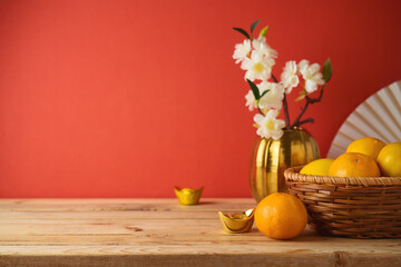 Chinese New Year decorations on wooden table over red background