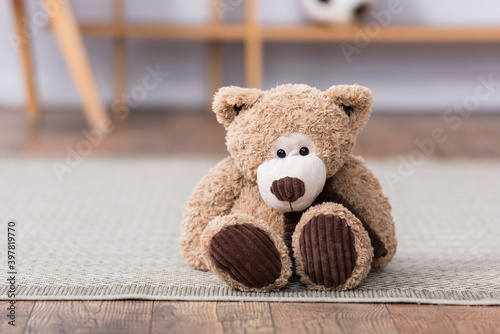 Teddy bear on floor on blurred background