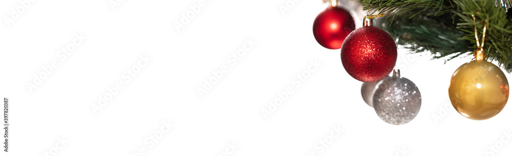 Decorative glass white, golden, and red glittering ball ornaments on Christmas tree. Some balls and tree are blurred. Isolated on white background. Winter holiday decoration. Banner size, copy space Decorative glass white, golden, and red glittering ball ornaments on Christmas tree. Some balls and tree are blurred. Isolated on white background. Winter holiday decoration. Banner size, copy space