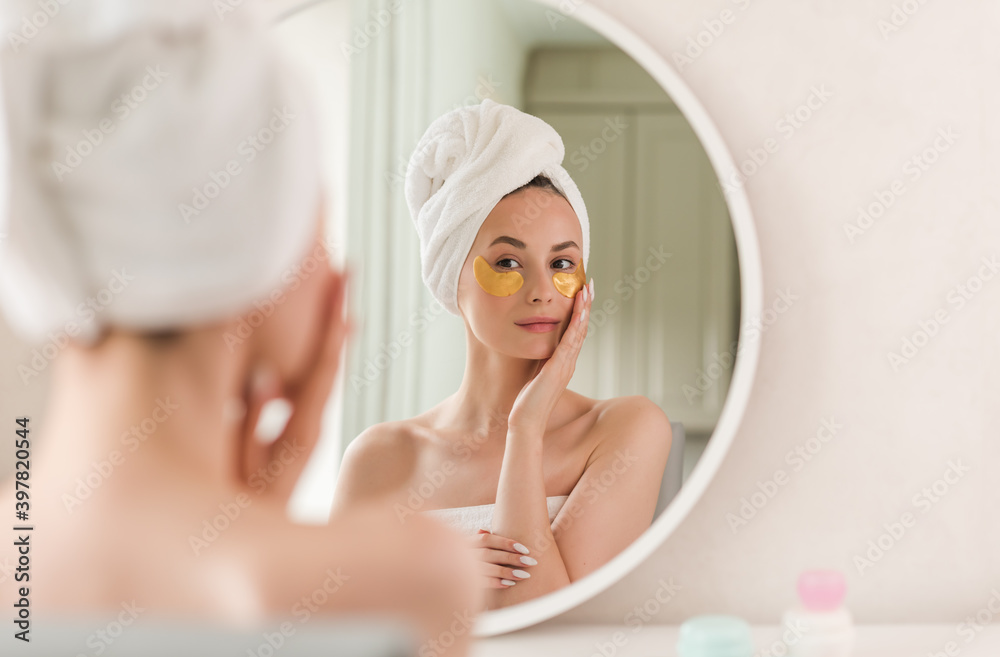 Portrait of Beauty woman with eye patches showing an effect of perfect skin. Beautiful face of young adult woman with clean fresh skin and bare shoulders. Portrait of Beauty woman with eye patches showing an effect of perfect skin. Beautiful face of young adult woman with clean fresh skin and bare shoulders.