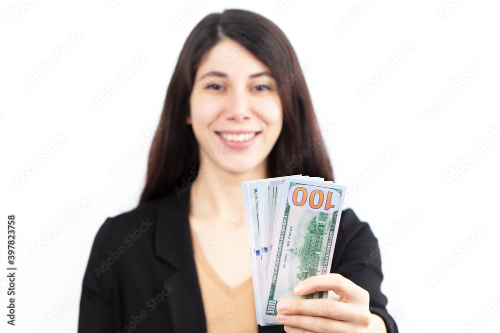 Business woman holding dollars in hand looking at camera isolated on white background.
Business woman holding dollars in hand looking at camera isolated on white background.