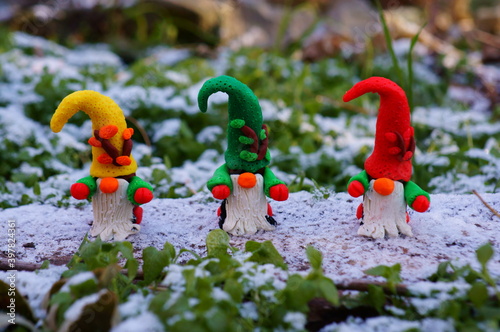 Figures of three dwarfs in a snowy forest.