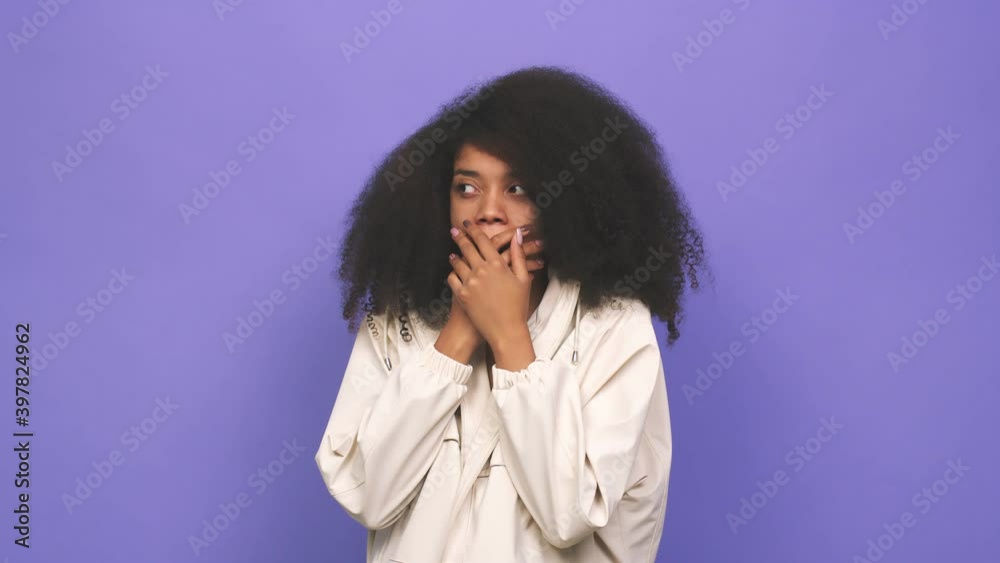 Young african american curly woman yawning showing a tired gesture covering mouth with hand Young african american curly woman yawning showing a tired gesture covering mouth with hand