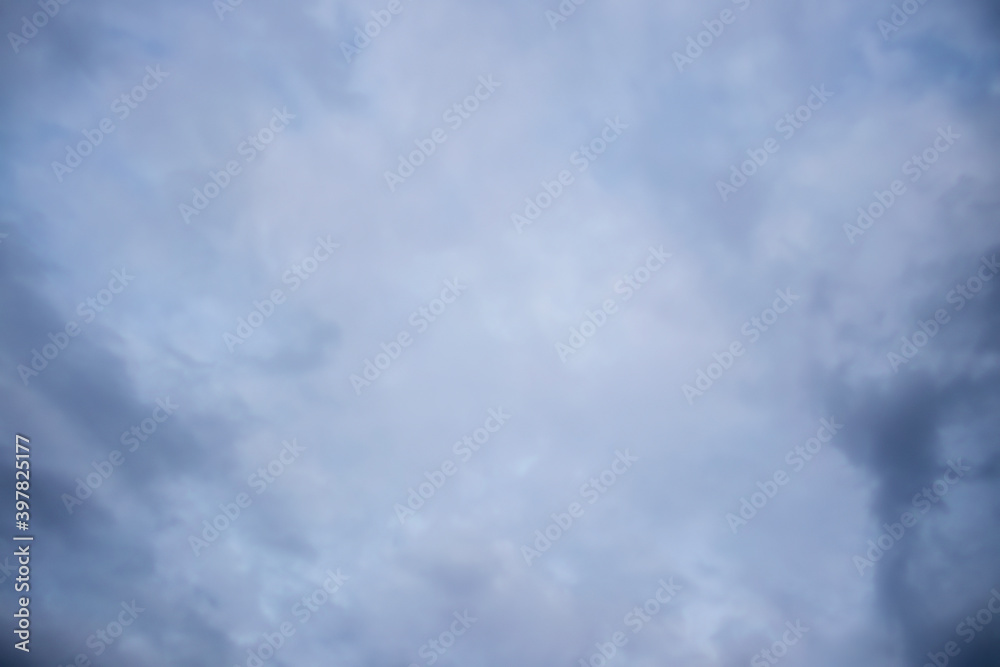 Overcast cloudy sky with hints of early sunset - purplish and turquoise hints - a storm brewing - background Overcast cloudy sky with hints of early sunset - purplish and turquoise hints - a storm brewing - background