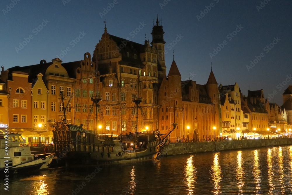 pirate ship in a city canal at night