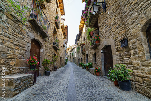 Fototapeta Naklejka Na Ścianę i Meble -  Street of an old medieval town with stone houses and cobbled floors, street lamps and an atmosphere of bygone times.
