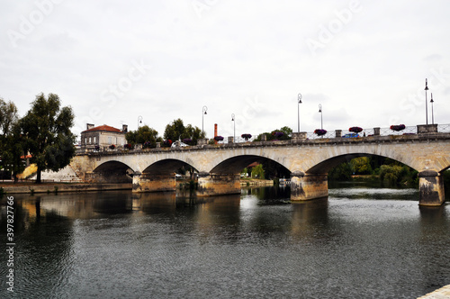 View of the Charente River. And a stone bridge across the river. Arched bridge NEF. © Viacheslav