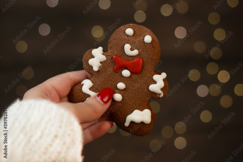 a woman's hand holds a gingerbread man a woman's hand holds a gingerbread man