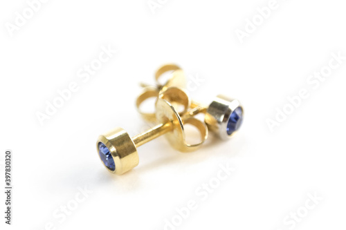 Gold stud earrings. Close up. Isolated on a white background