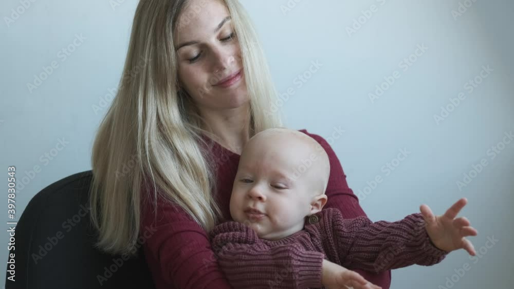 portrait of a blonde woman kissing her toddler son portrait of a blonde woman kissing her toddler son