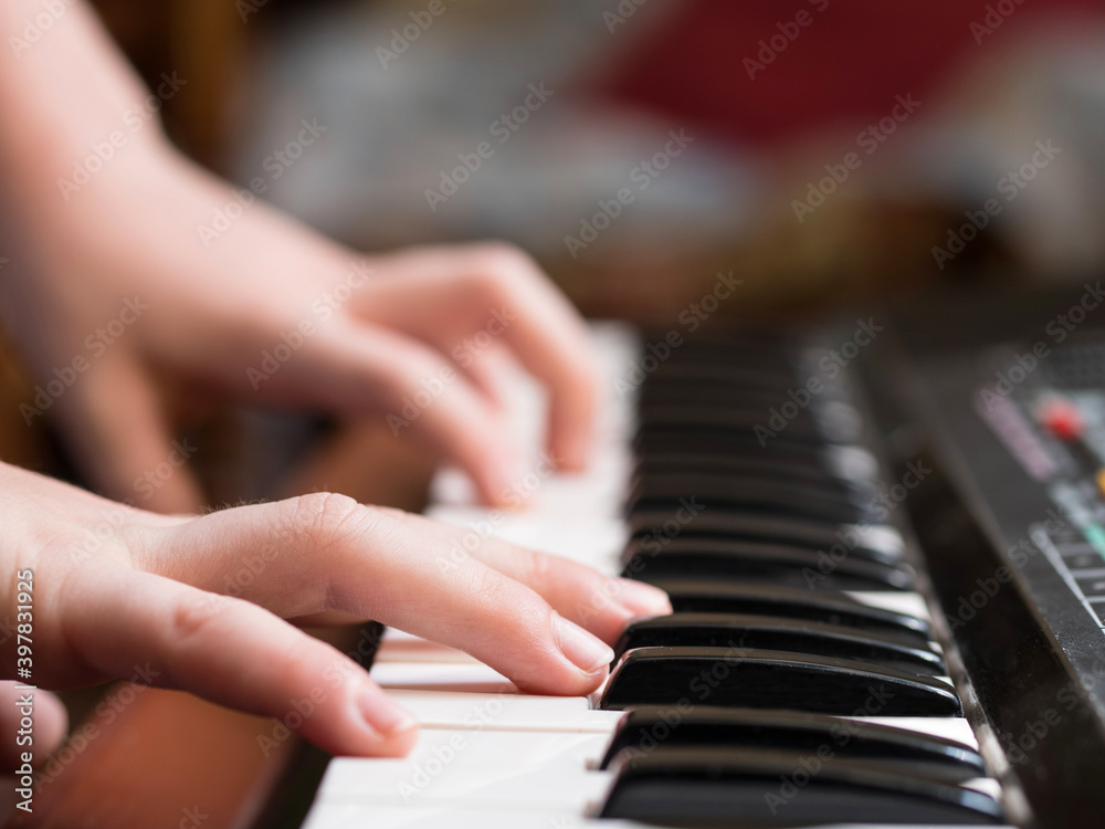 a child's hand playing piano