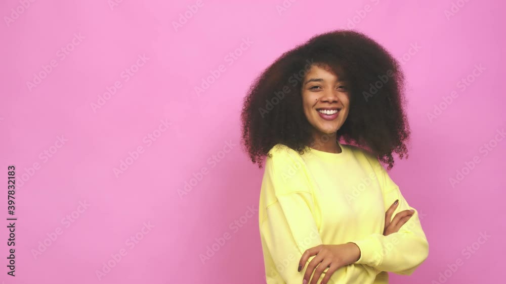 Young african american curly woman smiling confident with crossed arms Young african american curly woman smiling confident with crossed arms