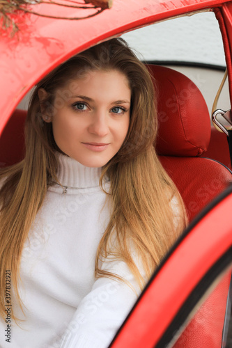 woman driving a red car