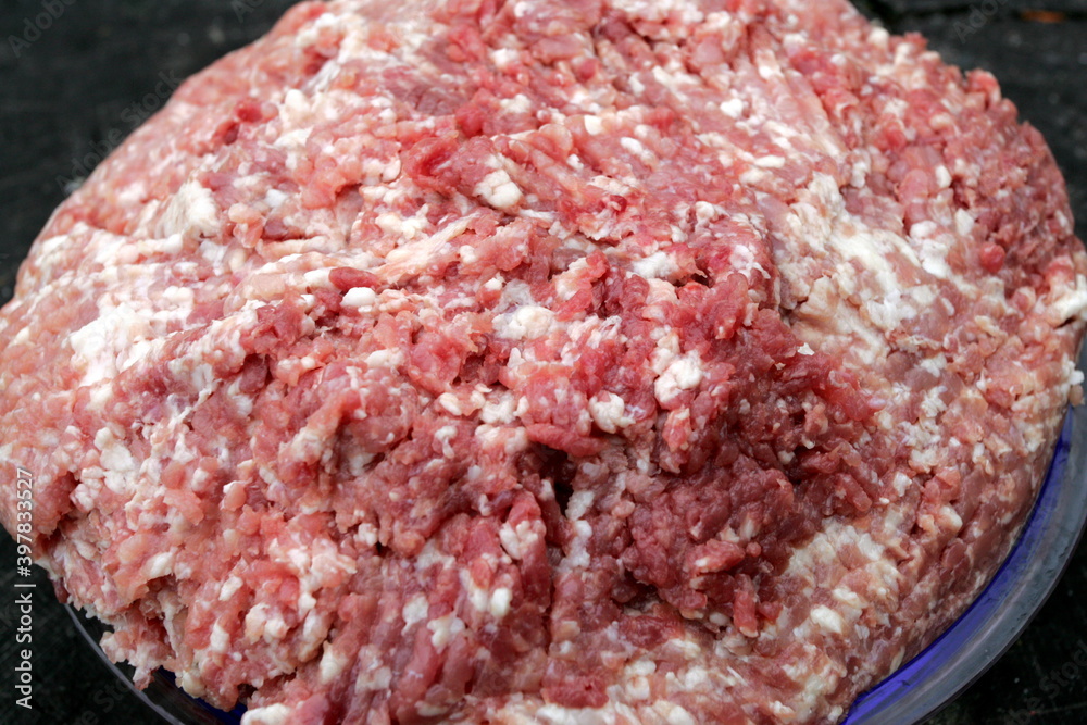 Fresh Raw mince, Minced beef. Close-up of minced meat in a glass bowl, Minced meat mix with fat for homemade sausage, Minced meat background Fresh Raw mince, Minced beef. Close-up of minced meat in a glass bowl, Minced meat mix with fat for homemade sausage, Minced meat background