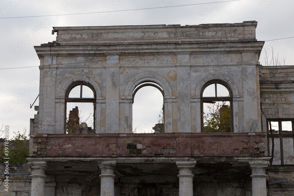 A ruined historic building against a gloomy sky.