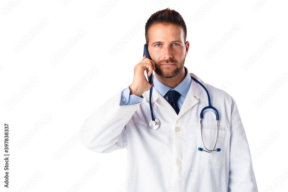 Male doctor using his phone while standing at isolated white background Male doctor using his phone while standing at isolated white background
