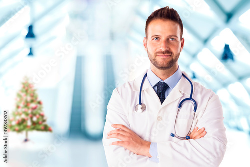 Male doctor standing in the hospital foyer at christmas time