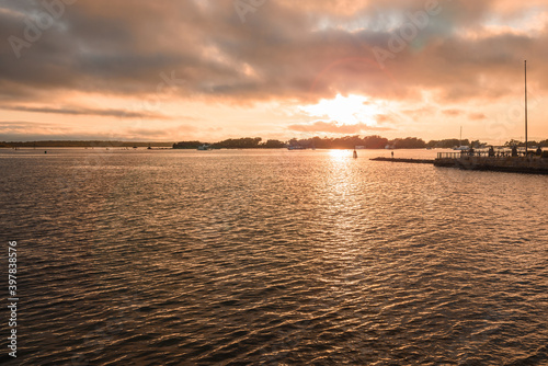 Beautiful sunset over a bay in autumn. Anchored boats are visible in distance. Falmouth  Cape Cod  MA  USA.