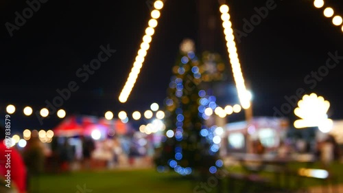 Blurred background bokeh night light Christmas tree deccoration in garden.