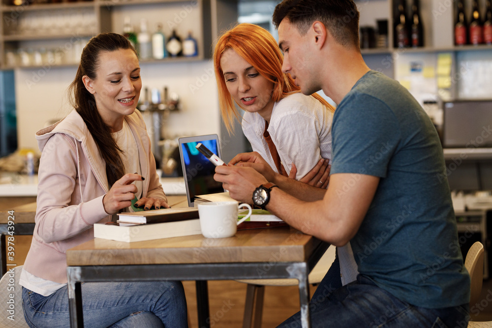 Group of university students hangout in college cafe library and preparing for lecture. Group of university students hangout in college cafe library and preparing for lecture.