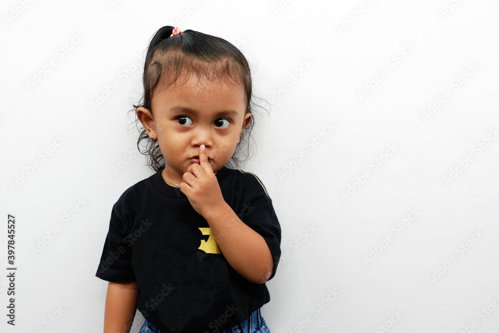 Little girl expression wearing a black t-shirt isolated on white background. Little girl expression wearing a black t-shirt isolated on white background.