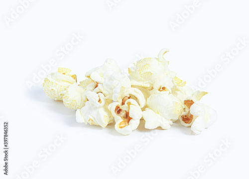 Image isolated close-up picture heap white popcorn pattern made of corn is a delicious food or snack to eat in the cinema use it as a white background image.