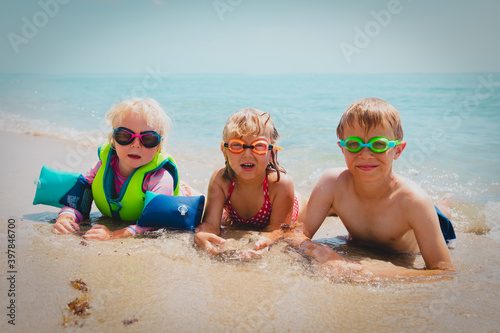 cute happy kids enjoy swim on beach