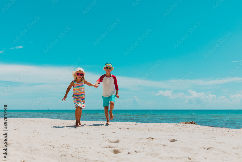 happy boy and girl running on tropical beach