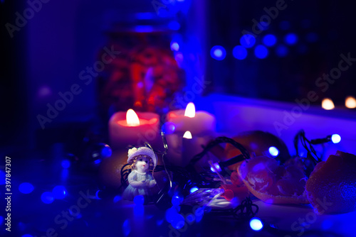 The window sill is decorated with garlands and candles for the new year.