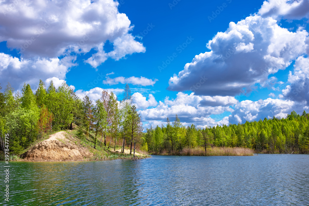Colorful summer landscape of the lake with clear water with a turquoise tint of blue sky. Background