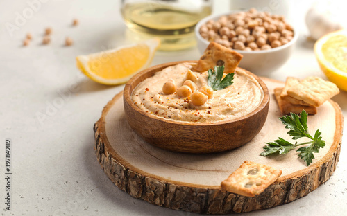 hummus in a wooden plate, chickpeas, croutons. Dishes of chickpeas, a vegetarian dish. Copy space.