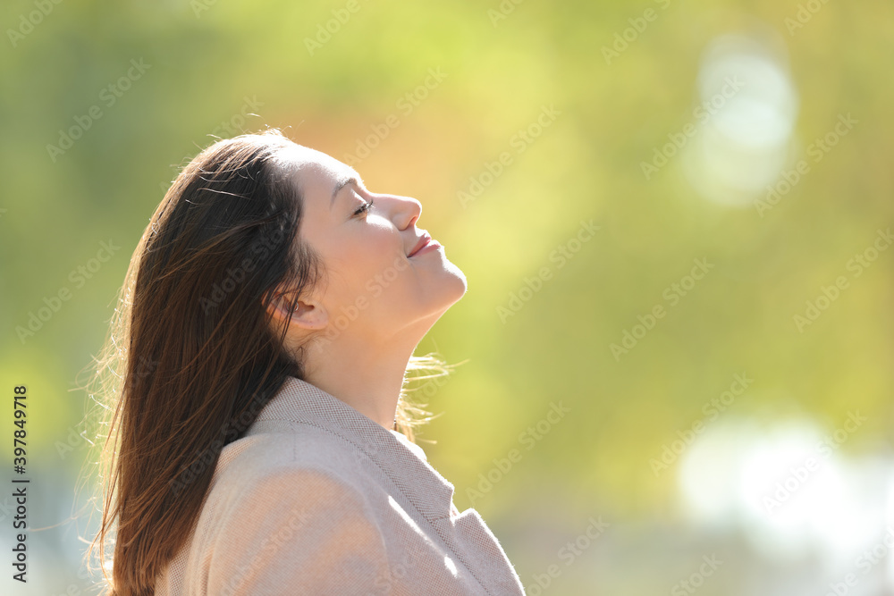 Relaxed entrepreneur breathing fresh air in a park Relaxed entrepreneur breathing fresh air in a park