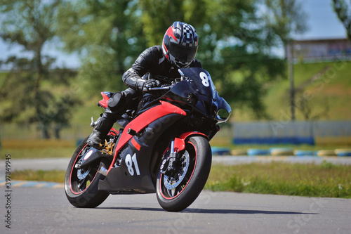 Road racing motorcykel in high speed into a curve  panning shot