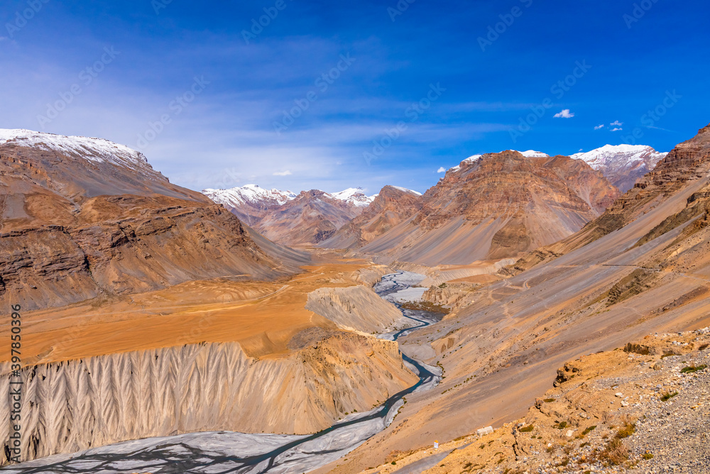 Serene Landscape of Spiti river valley with gully eroded and pinnacle geological weathered landform in cold desert arid region of Trans Himalayas Lahaul and Spiti district of Himachal Pradesh, India.