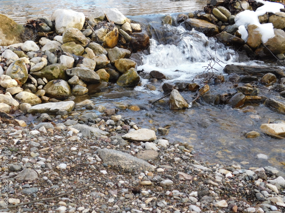 streem and stones in the water in winter on summer dam on river streem and stones in the water in winter on summer dam on river