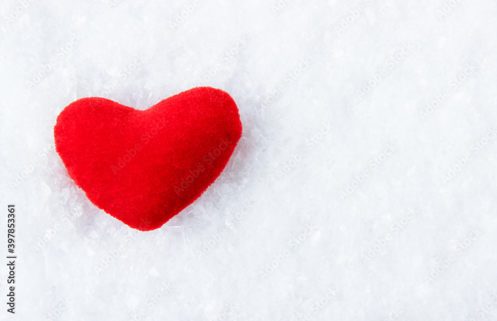 Bright red heart on a snowy, icy background. Copy space. Bright red heart on a snowy, icy background. Copy space.