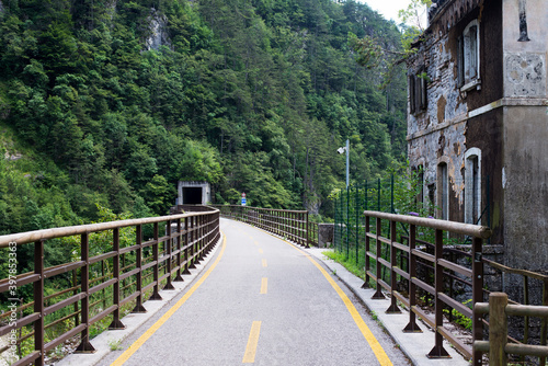 Ponteba Italy July 24th 2018. Ciclovia Alpe Adria on a former rail way. Old train tunnel in background. Radweg in Italy.