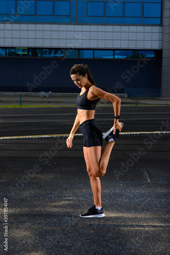 Athlete runner running on athletic track training her cardio. © Ivan Zelenin