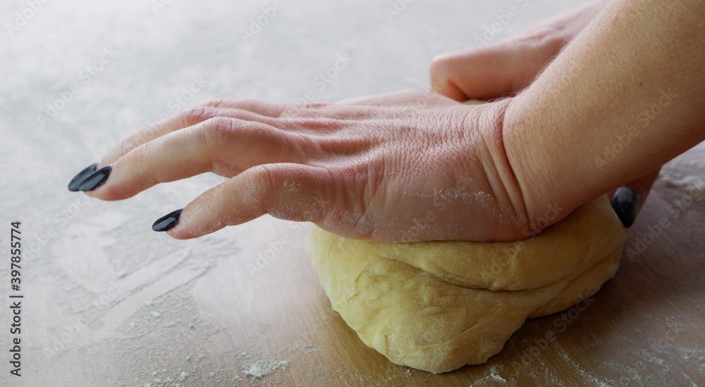 Making homemade dough by female hands on wooden table background. Cooking concept. Making homemade dough by female hands on wooden table background. Cooking concept.