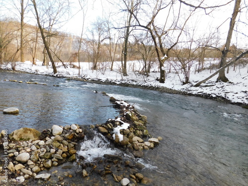 summer dam on the river in winter