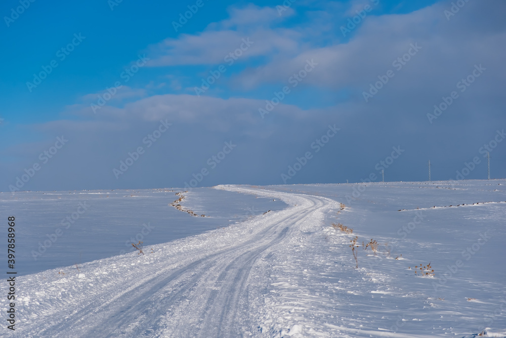 snow covered road at winter sunny day