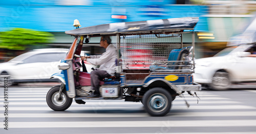 Bangkok rushing tuk tuk taxi in the city photo