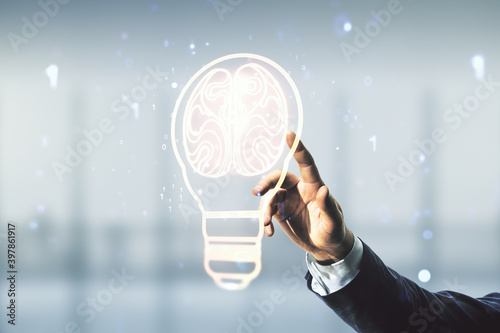 Double exposure of male hand presses on abstract virtual creative light bulb hologram with human brain on blurred office background, idea and brainstorming concept photo