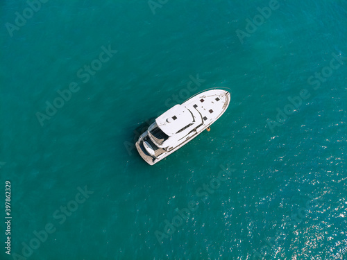 Awesome aerial top view photo of a laxury enormous two-storey yach sailing across the deer sea © Semachkovsky 