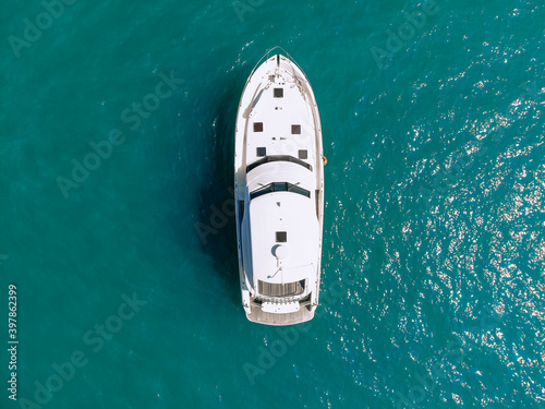 Awesome aerial top view photo of a laxury enormous two-storey yach sailing across the deer sea